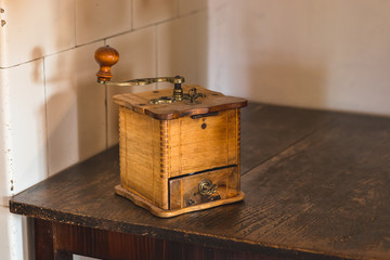 Vintage coffee grinder - old wooden manual coffee grinder in the kitchen