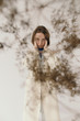 © Sergey Filimonov/Stocksy - Woman covering ears behind dried plant