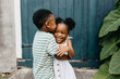 © Kristen Curette Photography LLC/Stocksy - Two African American kids / brother and sister hugging.