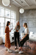 © Bonninstudio/Stocksy - Women discussing project in spacious office
