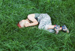 © Screen moment/Stocksy - Kid having fun outdoors..A little boy with red hair. The boy lies on the grass