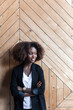 © Viktor Solomin/Stocksy - Corporate business style of young beautiful black african american woman posing in office