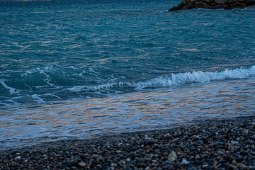 Evening on a coast. Abstract blue closeup on transparent background. Beach vacation. Water splash. Foam water. Liquid texture background. High quality photo