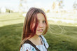 © JImena Roquero/Stocksy - Teenage girl in sunlight with backpack
