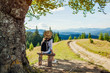© maryviolet - Trip to Carpathian mountains. Woman tourist hiking and relaxing admiring landscape. Traveling in summer Ukraine