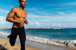© HEX./Stocksy - Close up of a Lean and Ripped Sport Man Body Running Beside the Sea on the Beach. Blue Sky on the Background