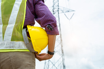 Poster - Electrical engineer holding safety helmet working at electric power.