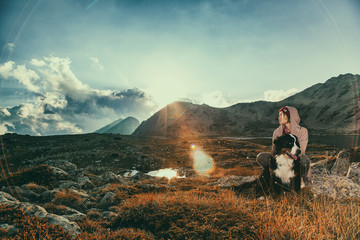 The girl travels in the mountains with her dog