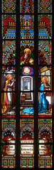 Wall Mural - Stained glass window depicting the Annunciation to the Virgin Mary by Gabriel the Archangel. St Martin's Cathedral, Bratislava, Slovakia. 2020/05/20. 