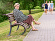 Mature sad woman resting in a city Park