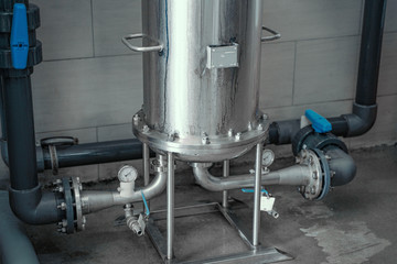Wall Mural - Round reservoirs or tanks with pipes for water filtration in modern beverage or factory.