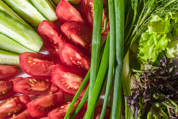 Wall Mural - fresh tomatoes, pepper, green onions and salad on a white plate. Top View