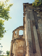 Wall Mural - Mystical Interior, ruins of facade of an abandoned ruined building of an ancient castle 18th century. Old ruined walls, corridor with garbage and mud. Ruins Ancient historic building destroyed by war