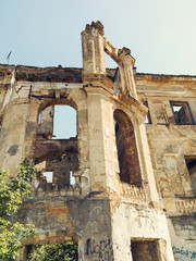 Wall Mural - Mystical Interior, ruins of facade of an abandoned ruined building of an ancient castle 18th century. Old ruined walls, corridor with garbage and mud. Ruins Ancient historic building destroyed by war