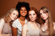 © iordani - young pretty caucasian, afro, scandinavian woman posing cheerful together on brown background, lifestyle diverse nationality people concept