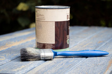 Can Of Paint And Brush On A Wooden Background. Tools For Painting. Open Jar Of Paint. Tin Of Paint