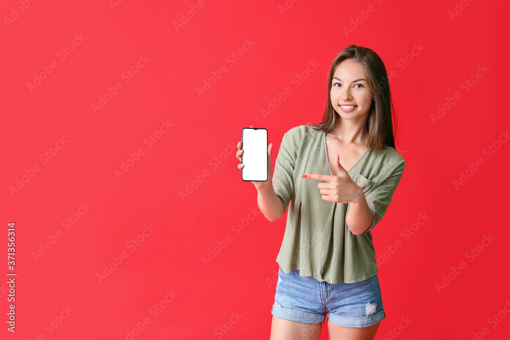 Beautiful young woman with mobile phone on color background