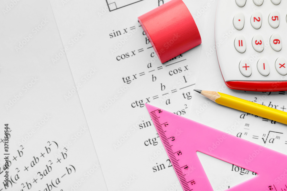 School stationery and paper with formulas, closeup