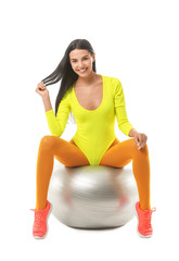 Wall Mural - Young woman doing aerobics on white background