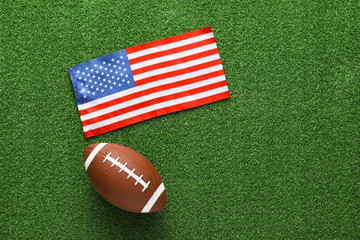 Rugby ball with national flag of USA on green grass