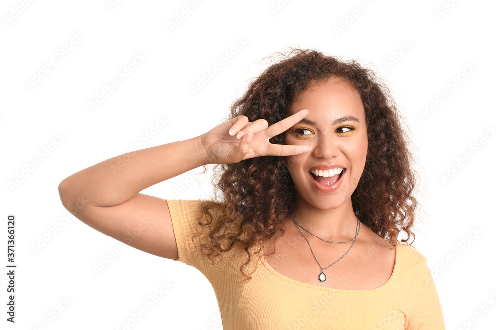 Young African-American woman with beautiful eyeshadows on white background