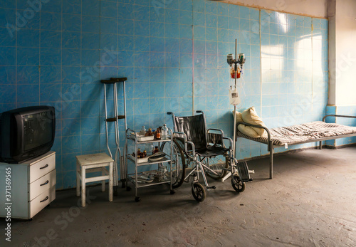 Creepy abandoned recovery room with a wheelchair in the hospital