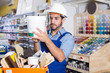 © JackF - Adult workman choosing materials for renovation works in paint store