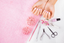 beautiful pink manicure with rose,manicure set, on the white and pink towels. spa concept