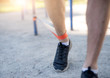 © Ievgen Skrypko - Male legs training with elastic rubber outdoors, close up