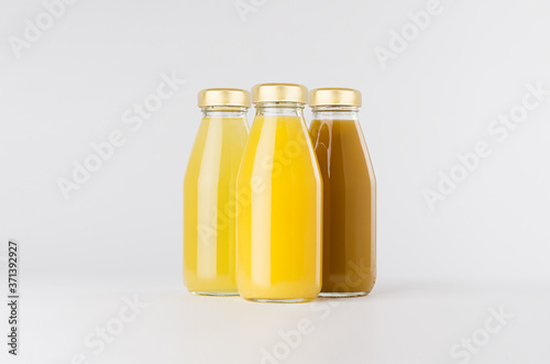 Orange, yellow fruit juices collection mock up in glass bottles with cap group on white background, template for packaging, advertising, design product, branding.