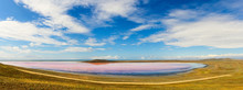 View Of A Small Pink Lake. Around The Lake Fields. Above The Lake Blue Sky With Clouds.