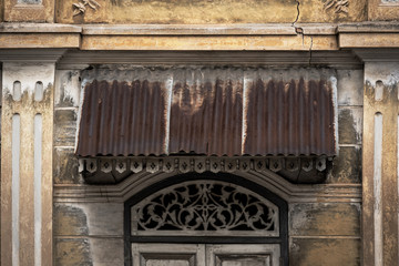 beautiful ancient wooden stencil engraving windows and stucco pattern with and old yellow historical