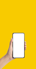 Poster - mockup hand holding mobile blank screen on yellow background.mockup banner display of content to advert on media.Clipping path on both hand and smartphone screen