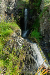 Wall Mural - Waterfall on Port Mora beach, Scotland