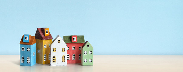 Wood miniature multicolor house on wooden table.