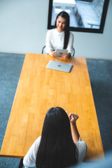 two people talking on table and keep distance, social distancing concept