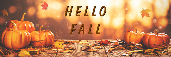 Wall Mural - mini pumpkins and leaves on wooden table with 