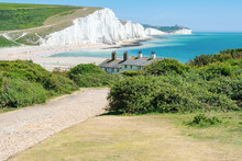 Walking Route In Cuckmere Beach Near Seaford, East Sussex, England. South Downs National Park. View Of Blue Sea, Cliffs, Beach, Green Fields, Selective Focus