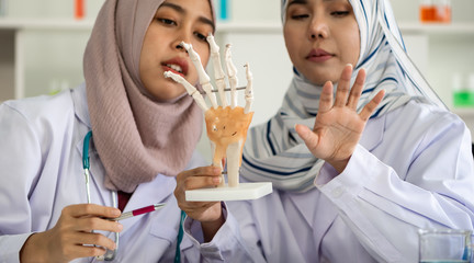 Young doctor study about hand anatomy.