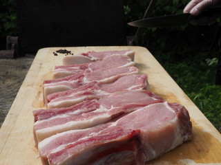 pork steaks on the bone on a wooden table . delicious pork loin steaks on the bone.