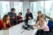 © godji10 - Group of cheerful multiethnic business people, company staff, and workers in a modern office. A successful diverse team of LGBT encourages one another at the workplace. Concept of gender equality.