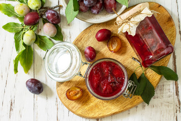 Wall Mural - Home preservation. Delicious plum jam on a wooden table. Top view flat lay.