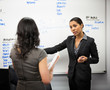 © Tetra Images - Businesswomen talking in office