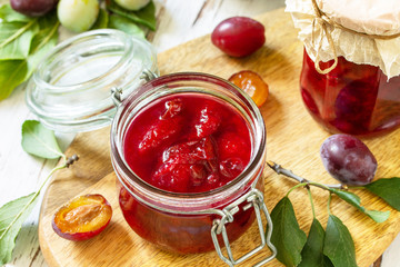 Wall Mural - Home preservation. Delicious plum jam on a wooden table.