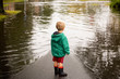 © Tetra Images - Caucasian boy wearing puddles near flood