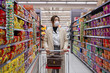 © View Stock - Wearing a mask of young women shopping in the supermarket