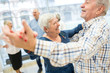 © Westend61 - Group of active senior attending dance course in retirement home