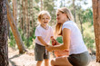 © irishasel - Mother and her child enjoy in the woods near the camping.
