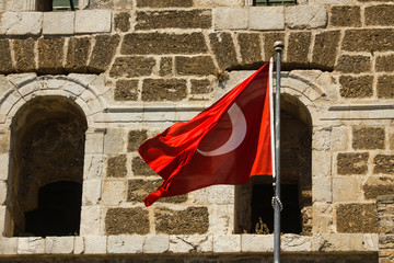 Wall Mural - turkish flag waving in front of the ancient theater of aspendos-antalya city in turkey