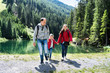 Family With Child Girl At Mountain Lake In Austria